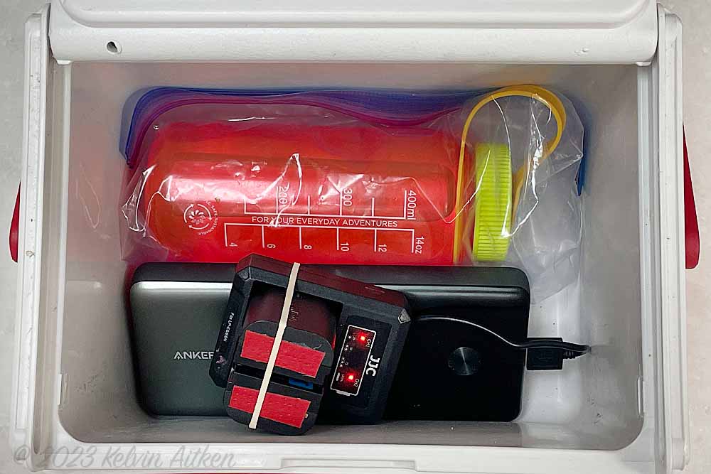 Small cooler with Nalgene bottle to keep battery charging system warm